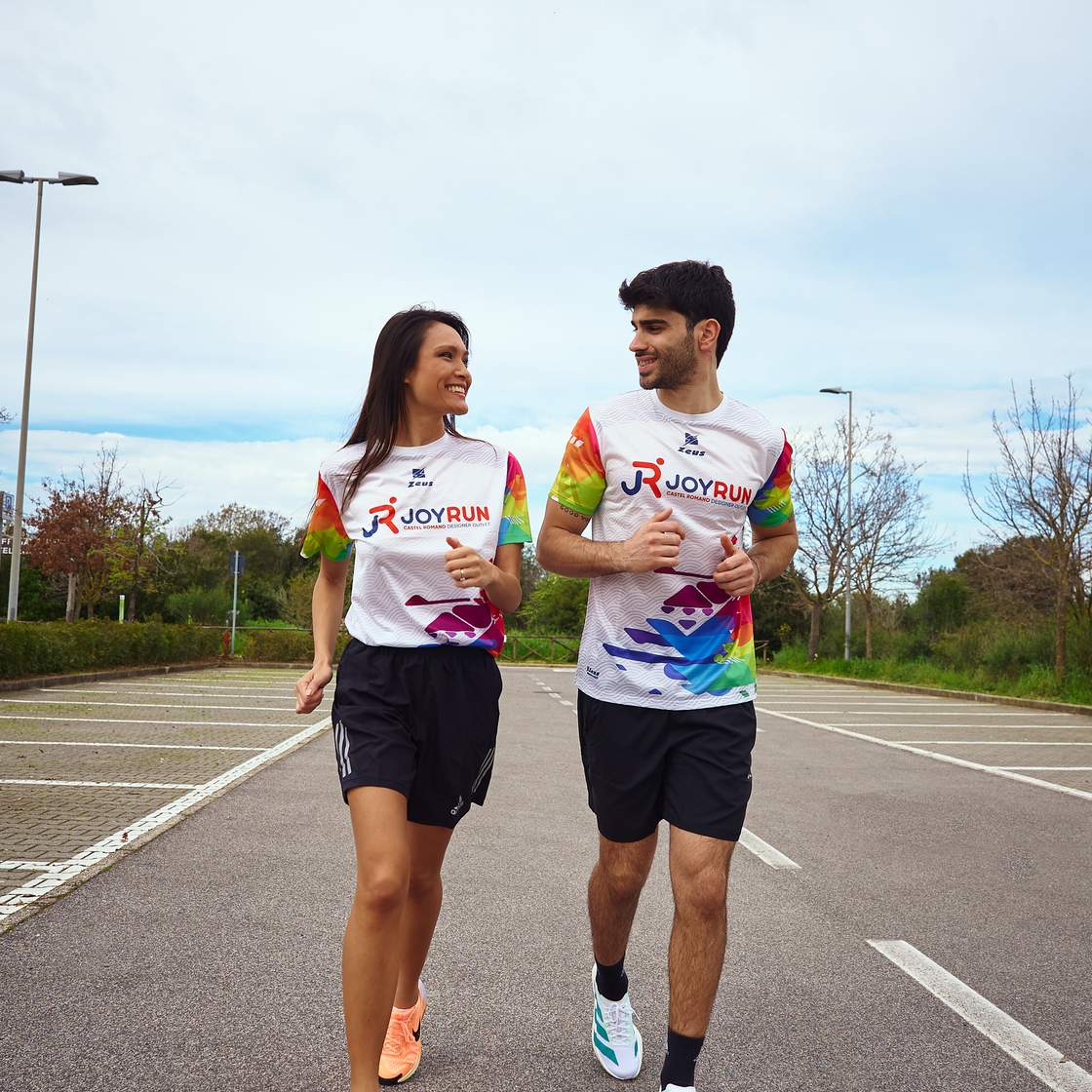 a boy and a girl are runnning in a street